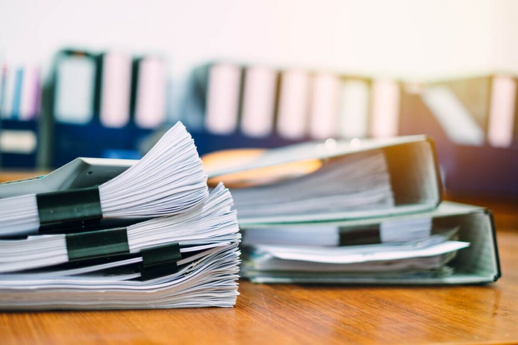 stacks of papers on a desk