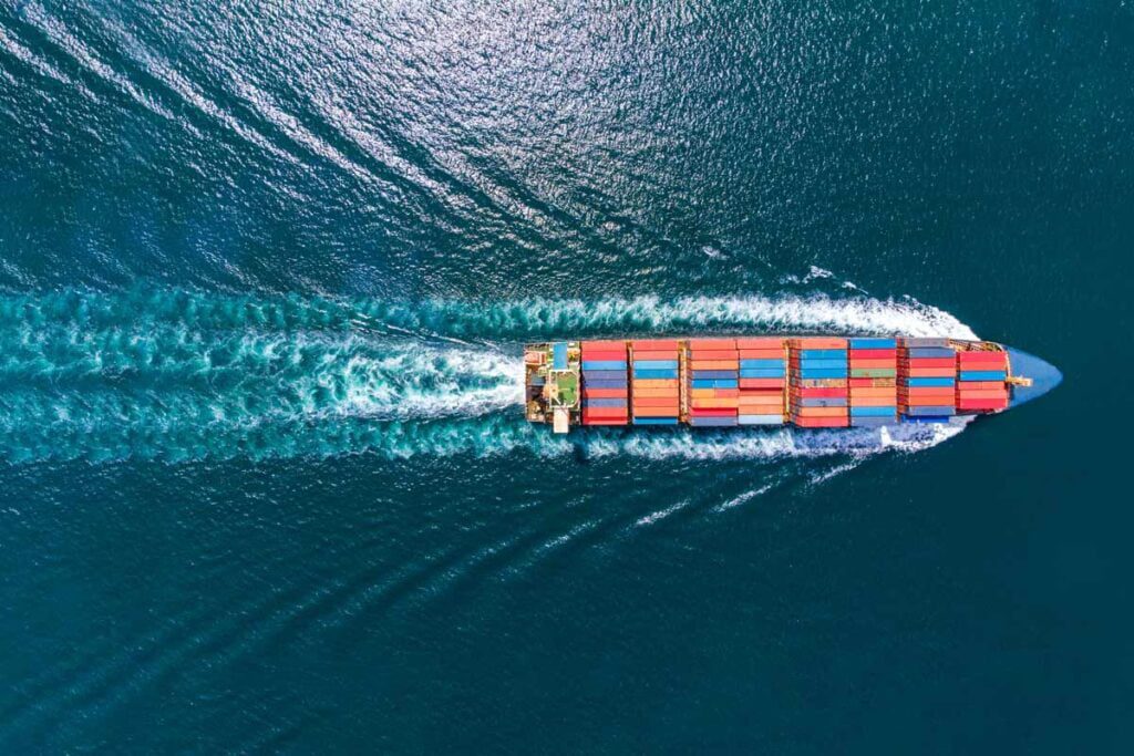 an aerial view of a cargo ship on the ocean