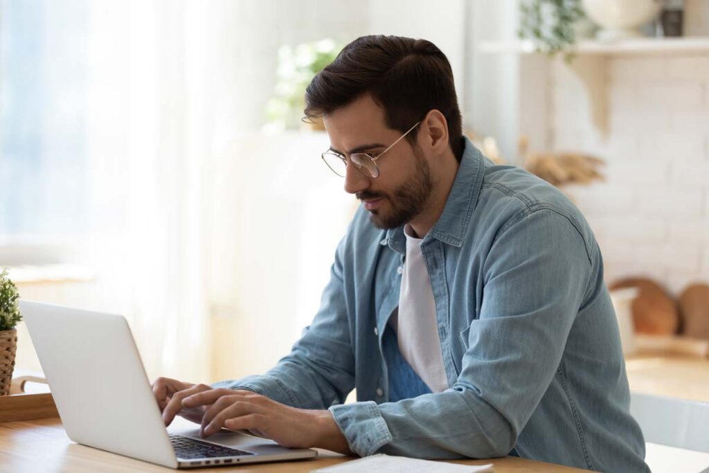 man sitting at computer