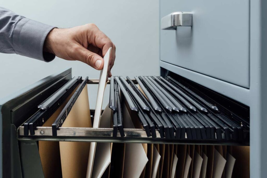 hand pulling file out of cabinet