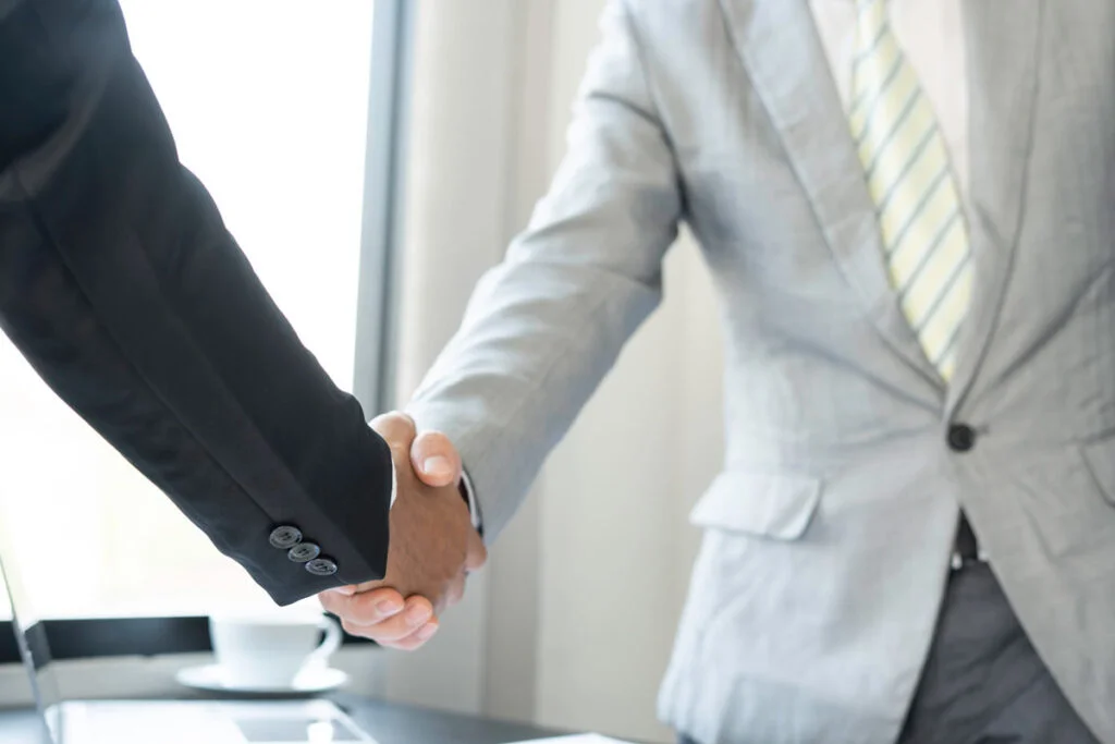 2 business people shaking hands
