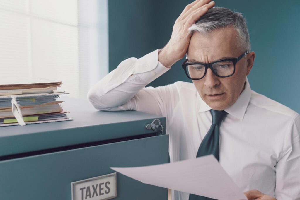 man looking frustrated at a documents