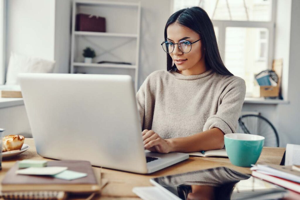 woman sitting in front of computer at home