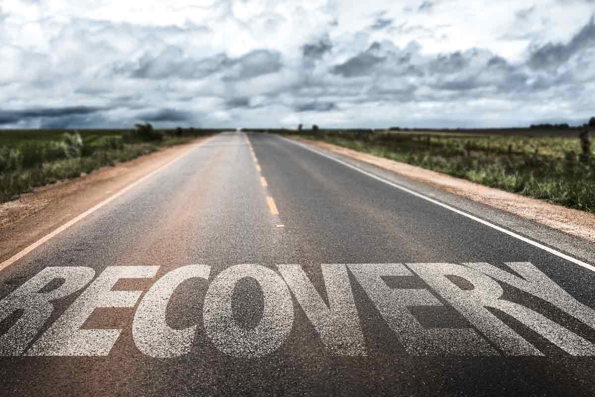 "Recovery" written in large letters on a road