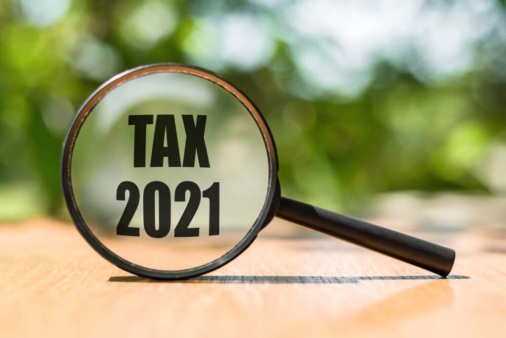 magnifying glass with the words "tax 2021" inside the glass