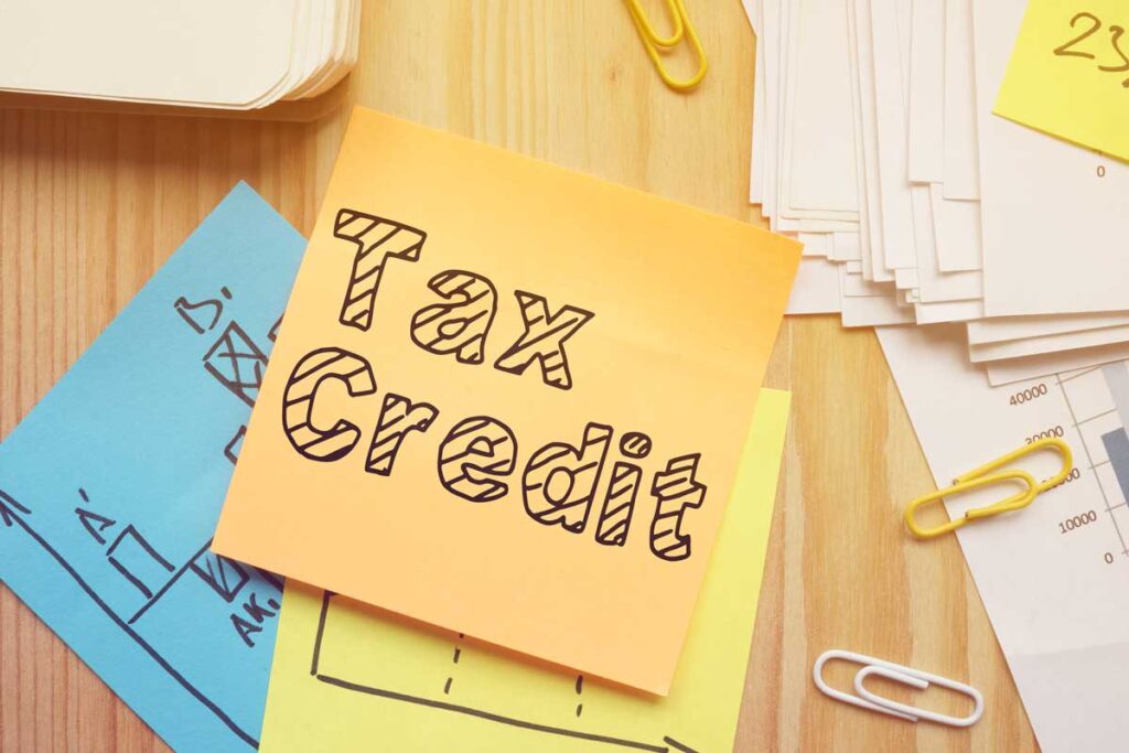 stack of sticky notes with "tax credit" written on top