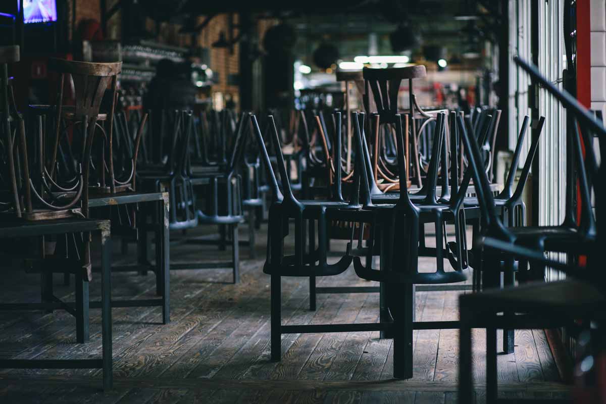 closed restaurant with chairs placed on top of tables