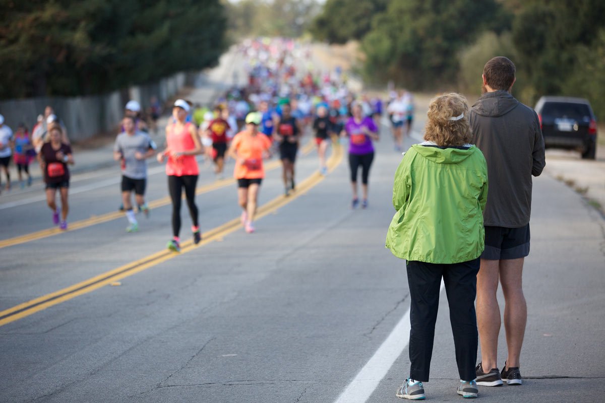 a couple of people cheering on runners