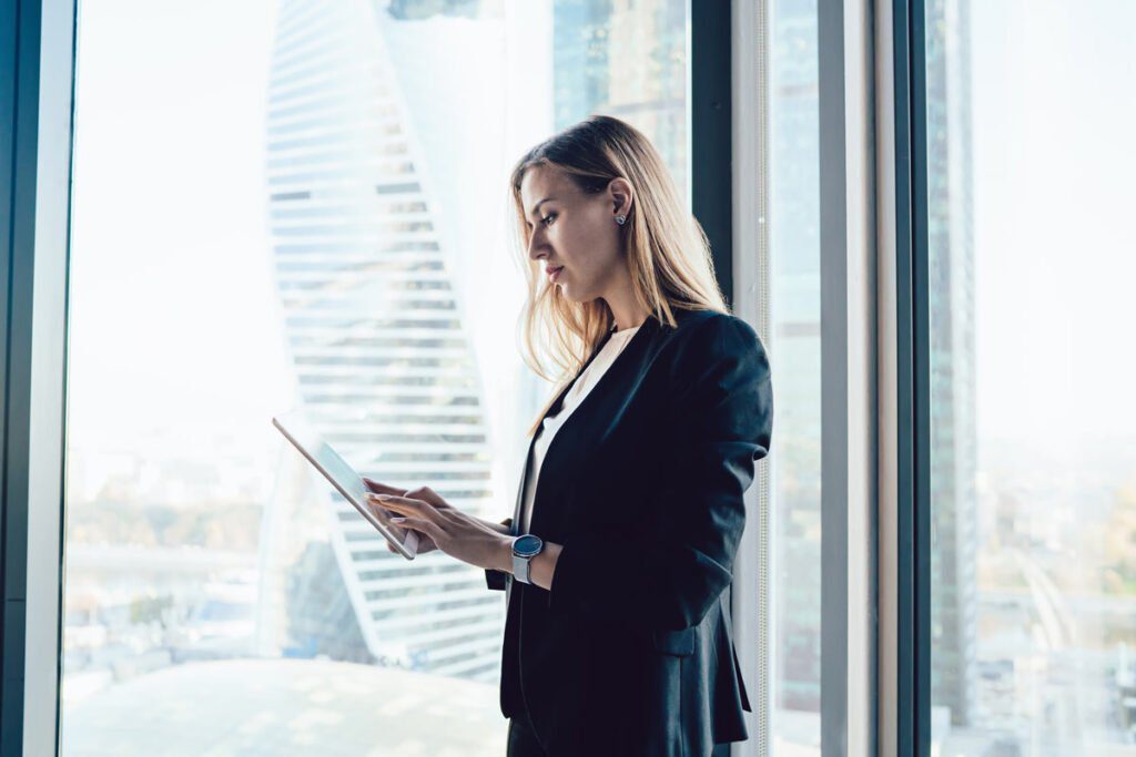 a businessperson looking a tablet in an office