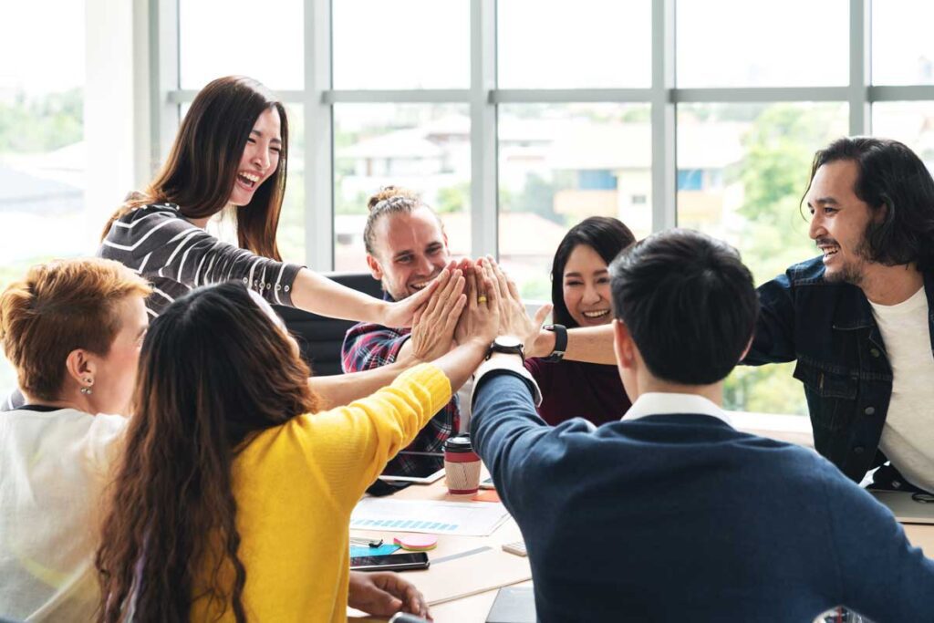 group of employees put their hands together