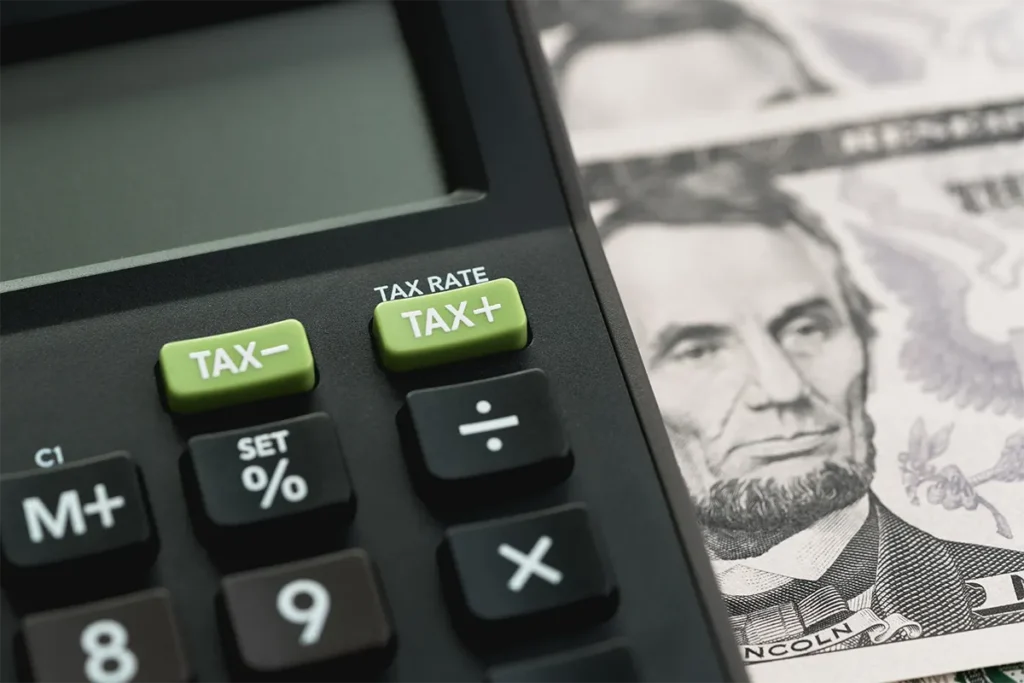 calculator against 5 dollar bill background