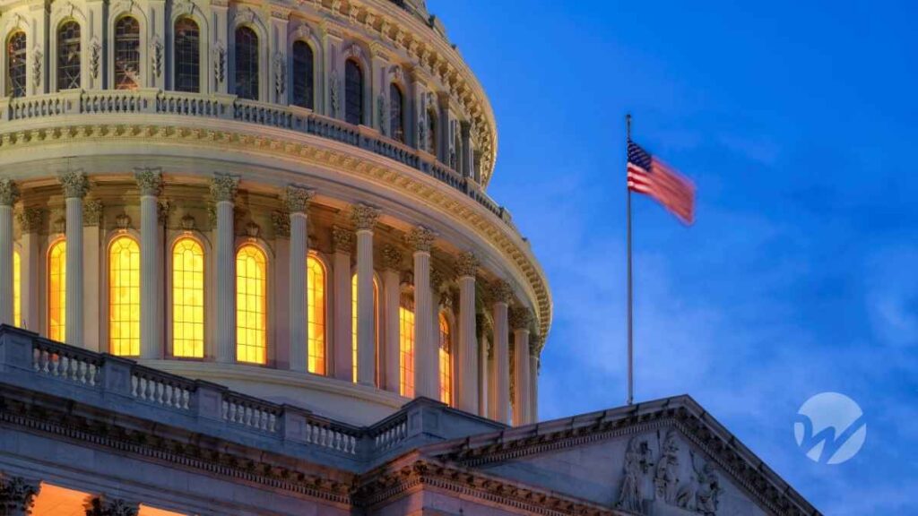 Close-up of the U.S. Capitol dome at dusk with glowing interior lights and an American flag waving against a blue sky, symbolizing ongoing federal legislative activity