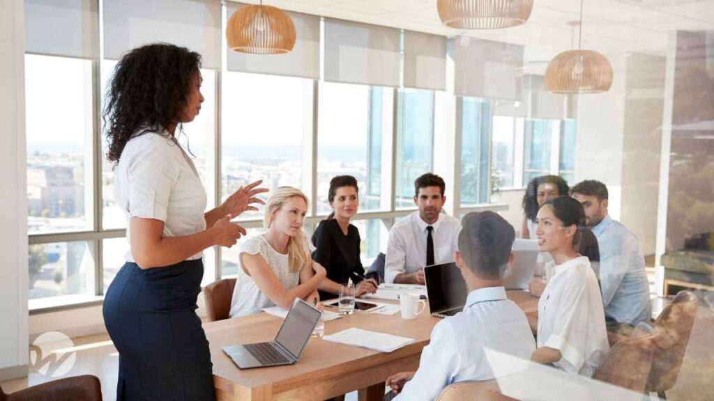 Nonprofit board meeting in a modern conference room, with a diverse group discussing financial policies and governance strategies.