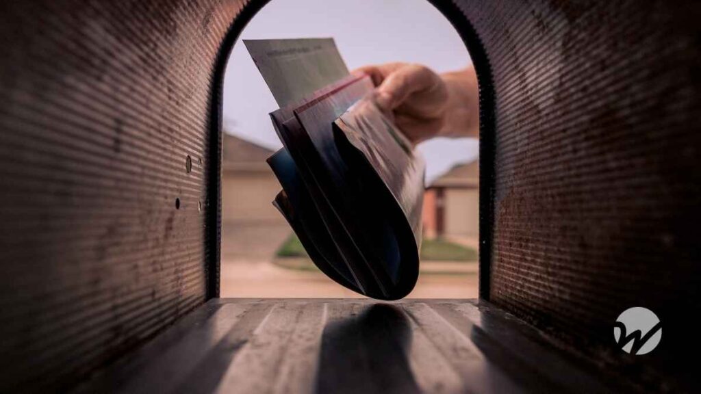 hand reaching into mailbox to gather mail
